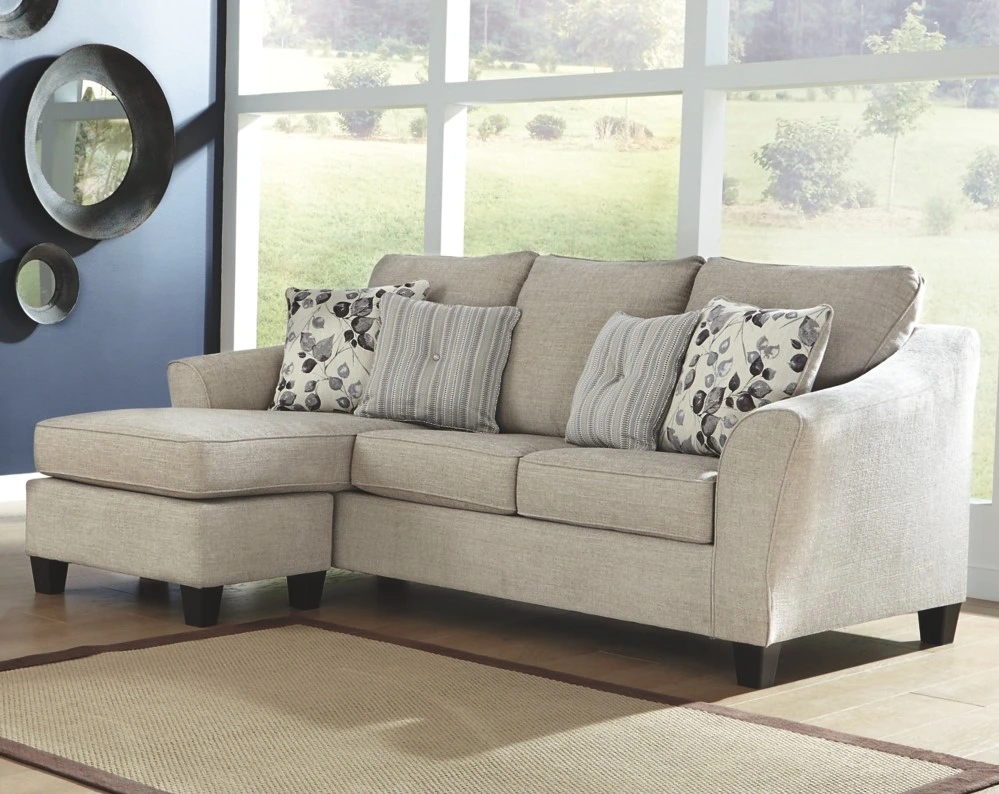 The Benchcraft Abney collection sofa chaise in a modern living room 