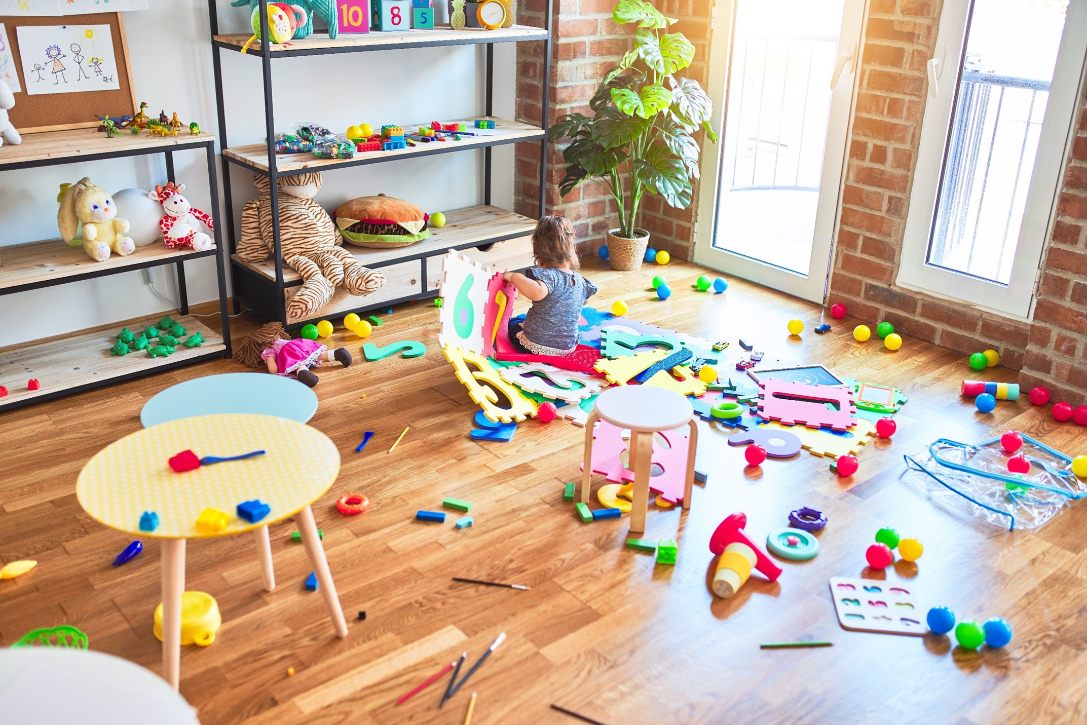 Children playing with various toys in a room 