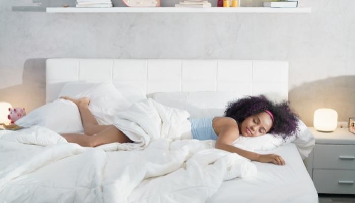 Woman sleeping crosswise on the bed