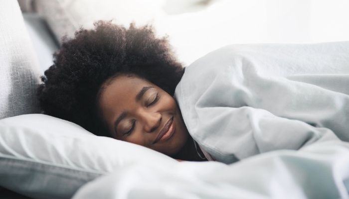 woman smiling in bed