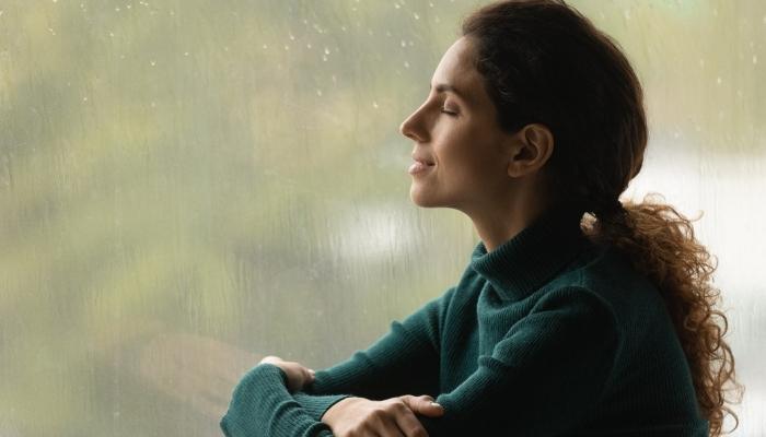 Woman listening to soft rainfall