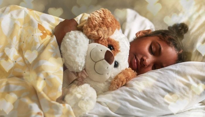 Young girl sleeping with stuffed animal