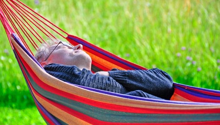 Man napping in a hammock outside