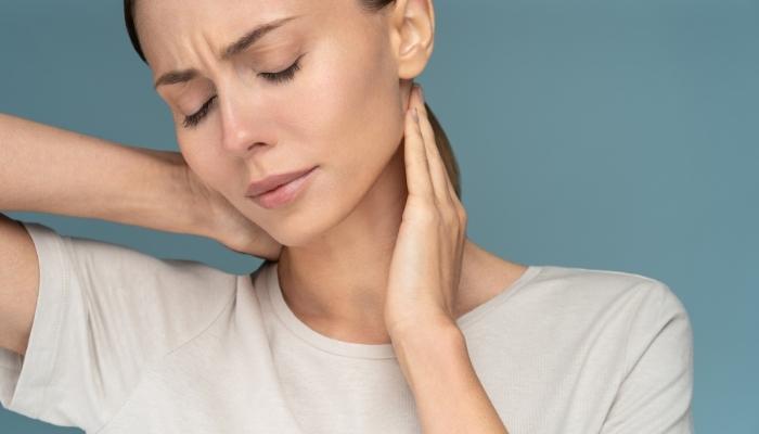 Woman feeling neck pain