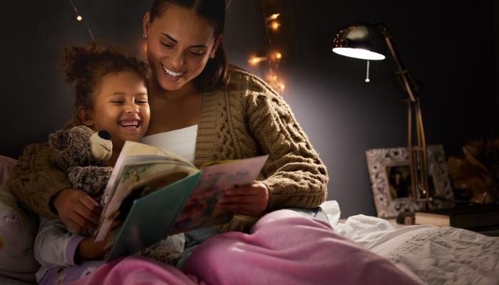 mother reading daughter bedtime story.