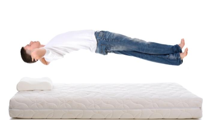 Man floating above mattress; pressure relief concept