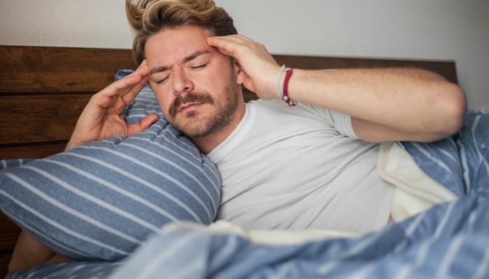 man waking up not well rested 