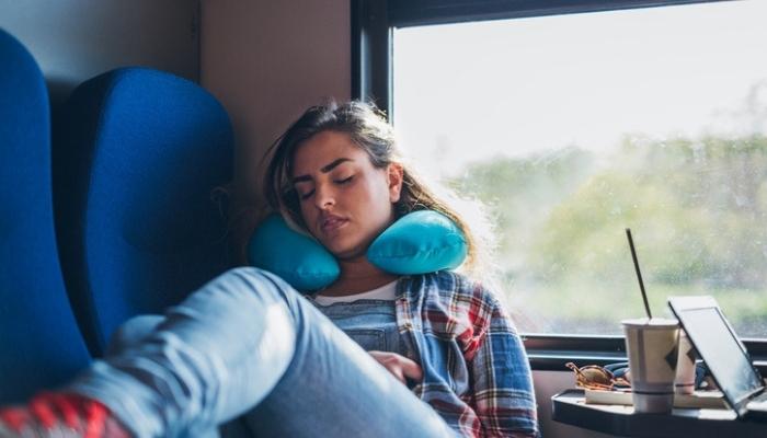 young woman napping on train