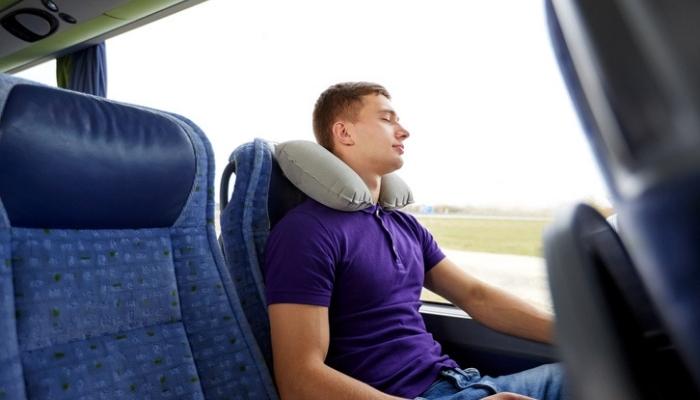 young man sleeping on a bus