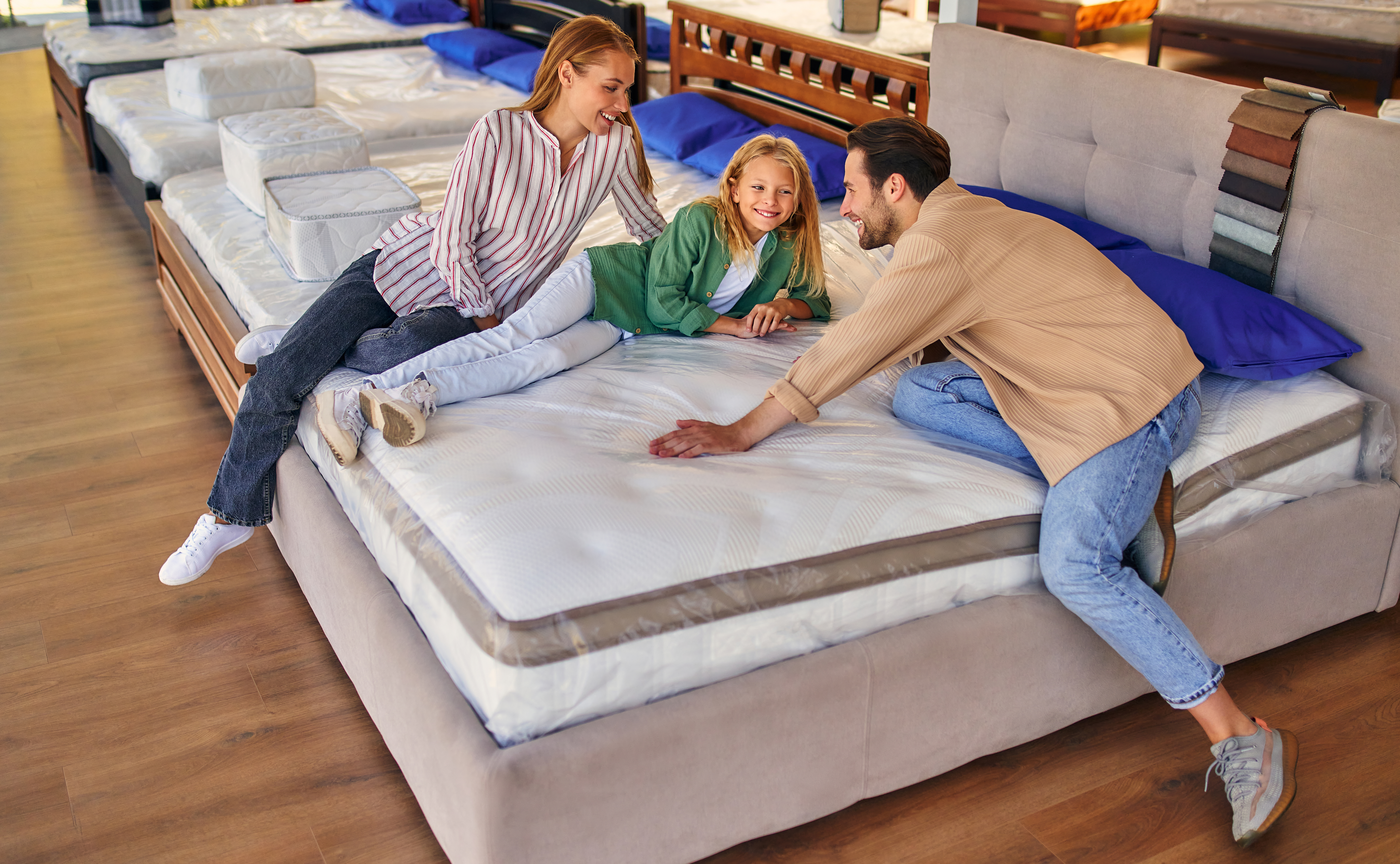 A family testing a mattress in a store 