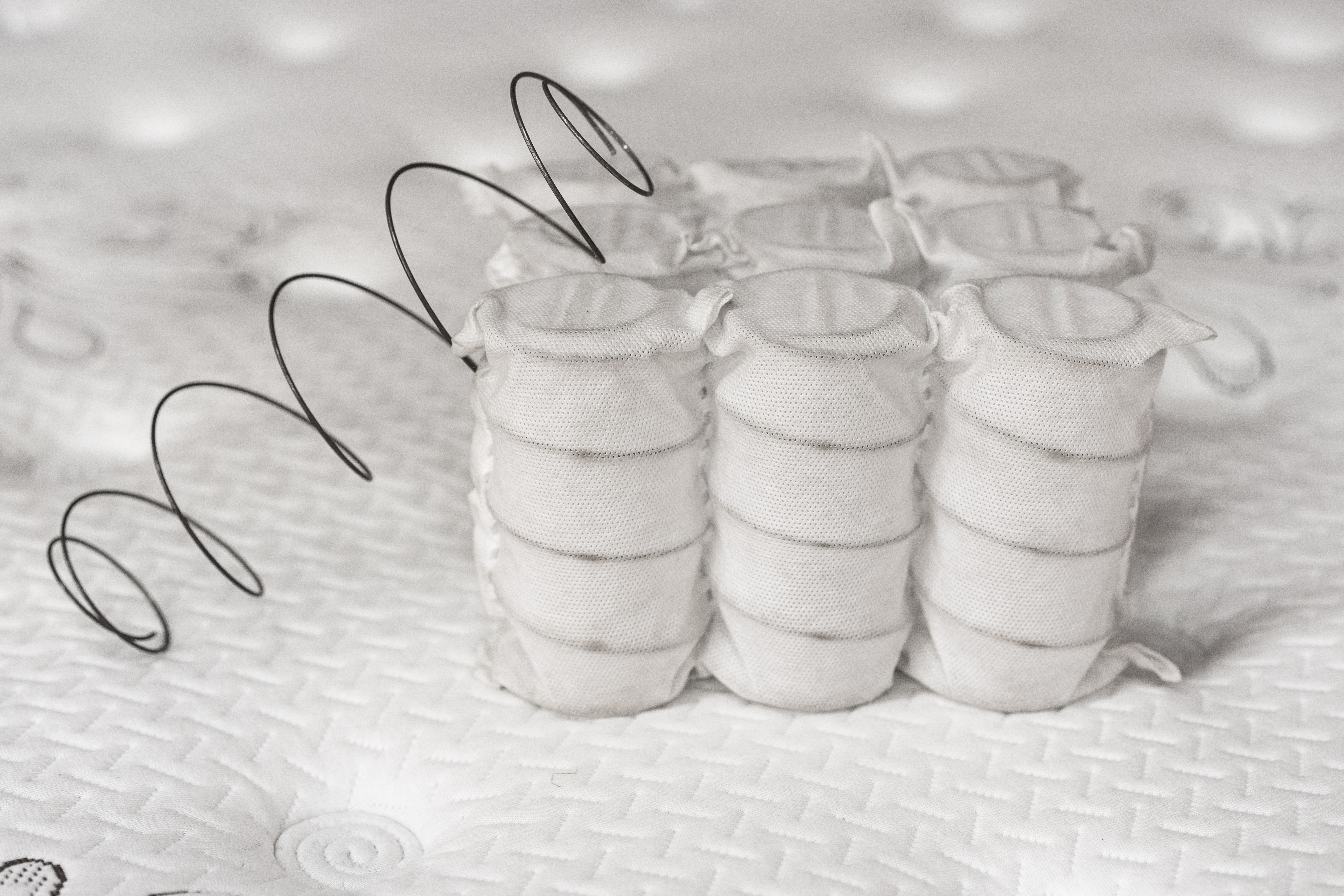 Side by side of traditional and pocketed mattress coils 