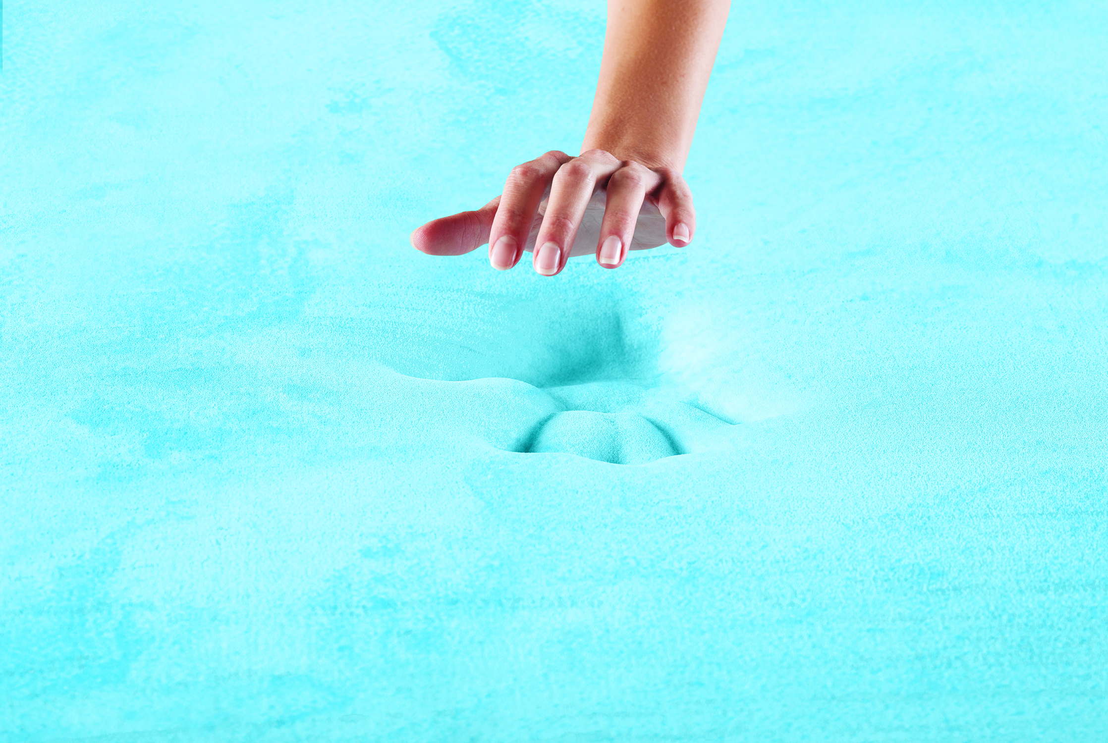 Person pressing into surface of a Serta QuiltLoft memory foam mattress 