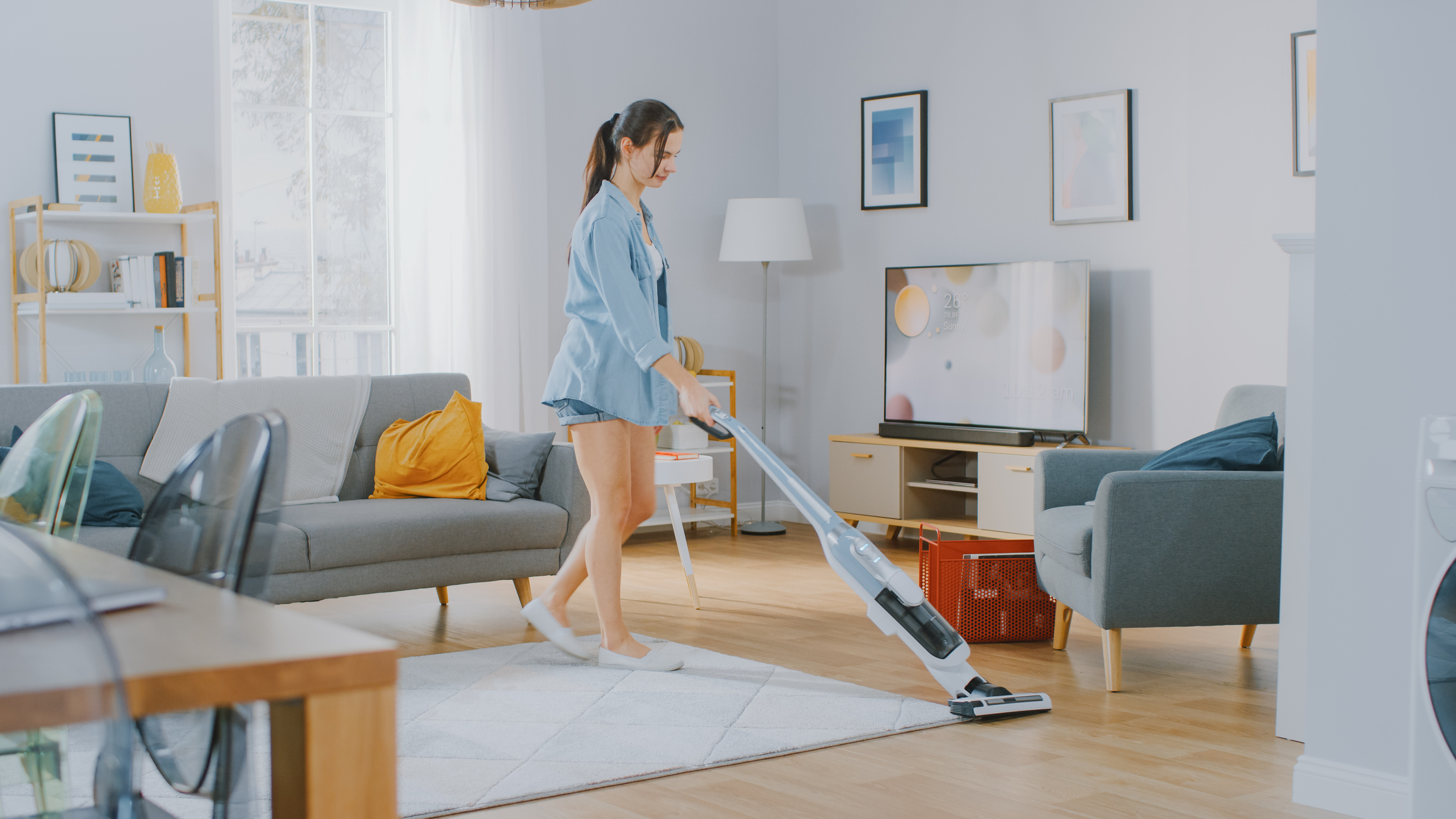 young woman vacuuming