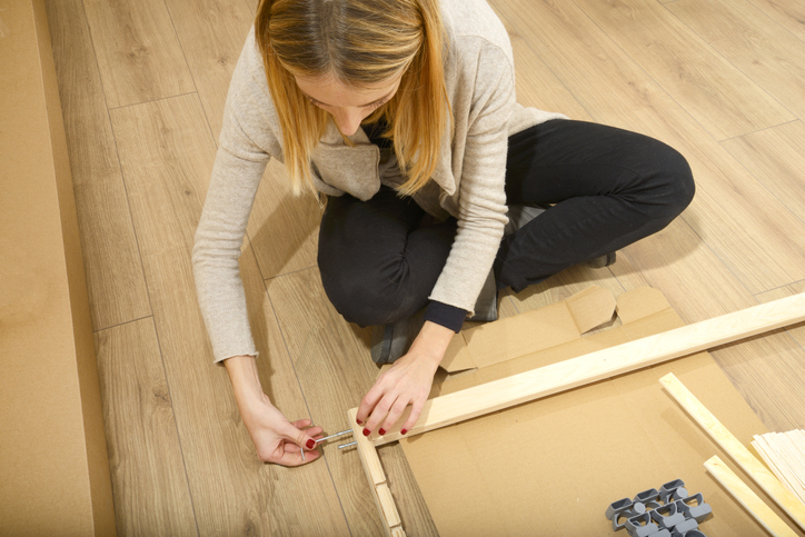 woman assembling furniture 