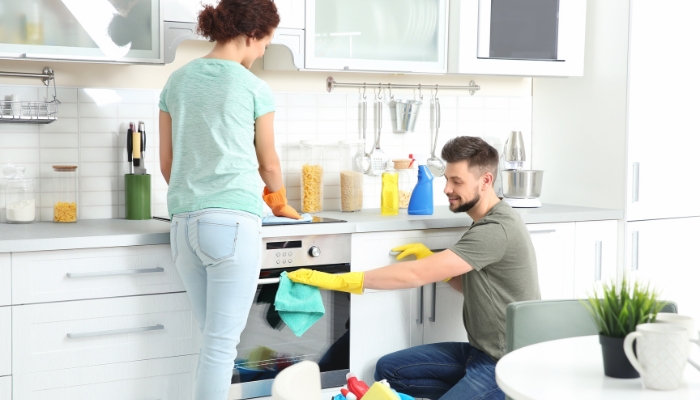 Couple cleaning their appliances