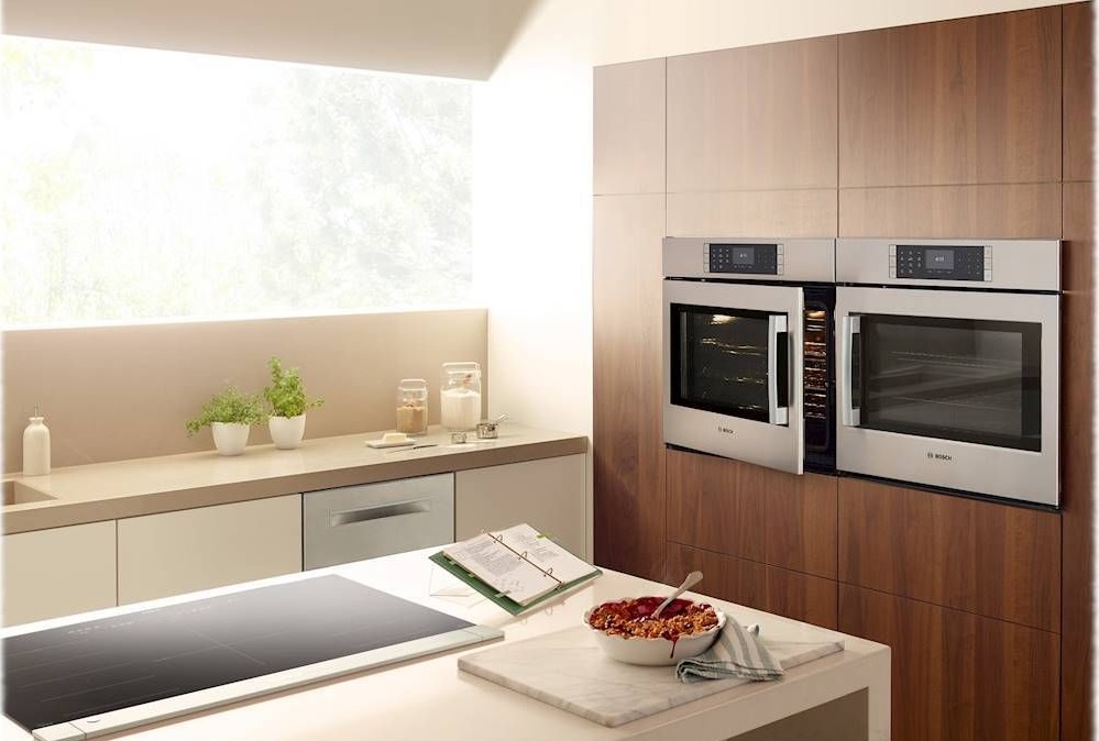 Wide shot of kitchen with two Bosch side-swing door ovens installed side by side 