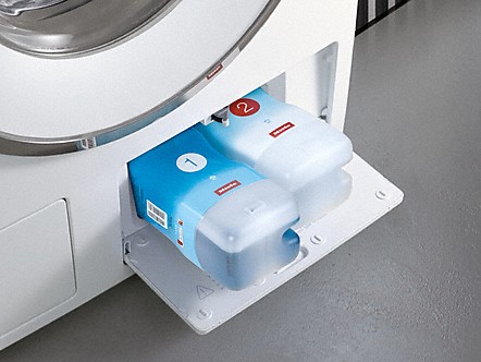 Closeup of TwinDos detergent cartridges on Miele compact washer 