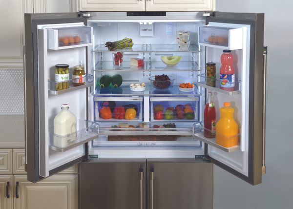A 4 door refrigerator stocked witth perishable fruits and vegetables