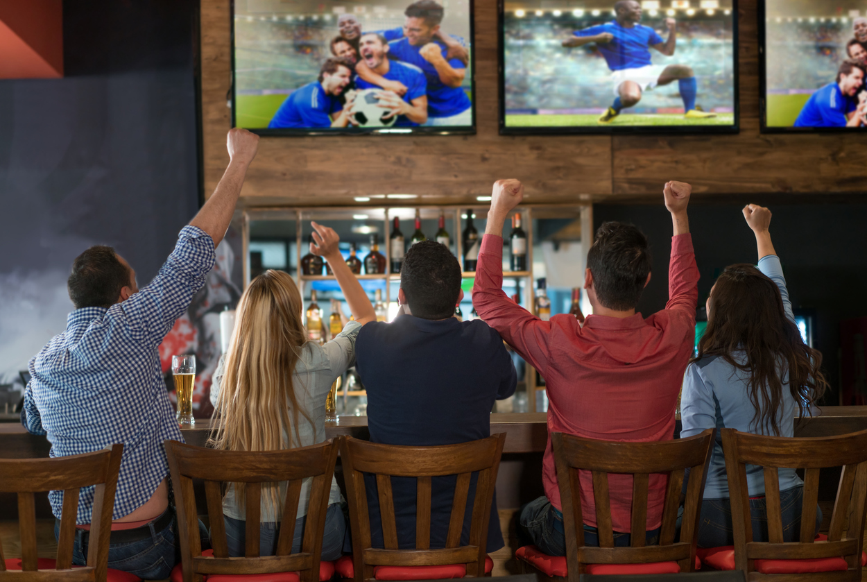 A family enjoying a sports bar installed in their basement.