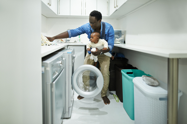 a father and his child do laundry together