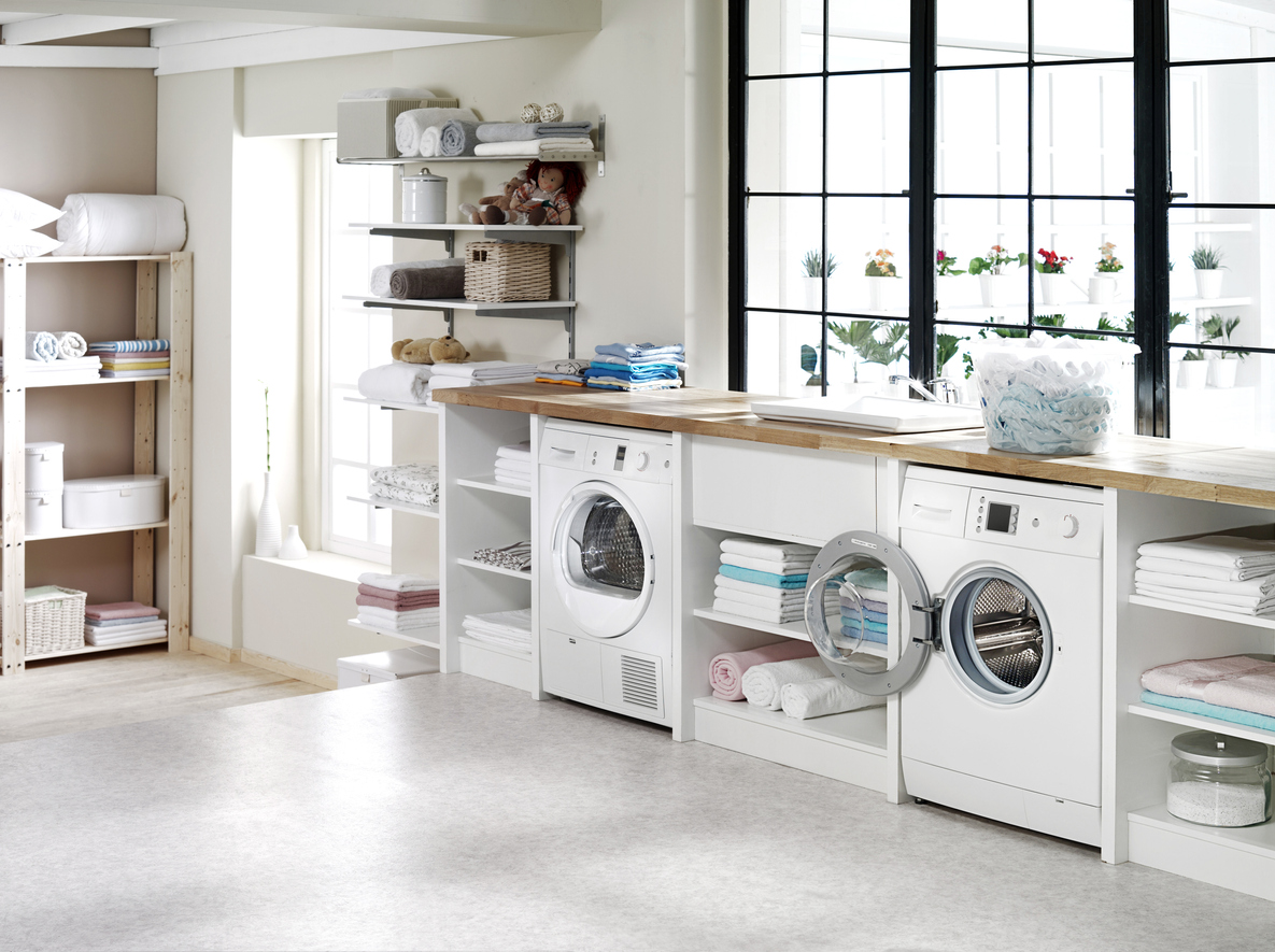 pair of matching front-load laundry appliances in bright white laundry room 