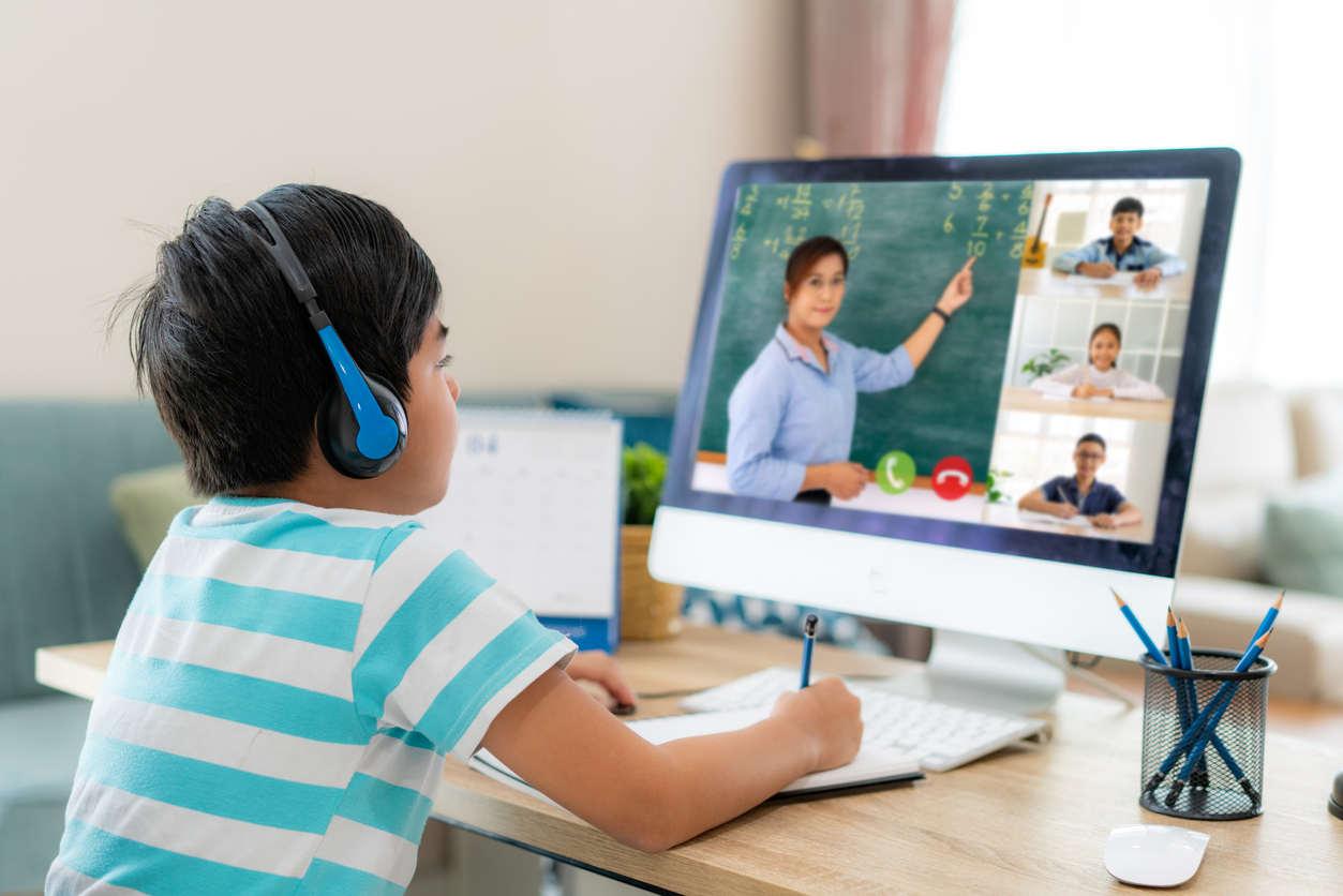 A student taking notes from a teacher remotely.