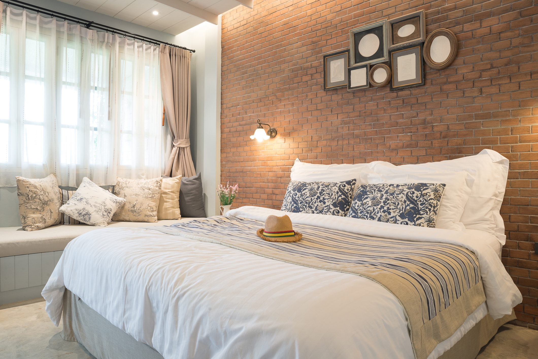 comfy guest room with brick backdrop 