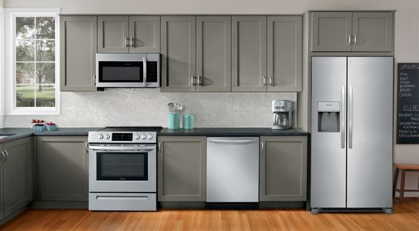 Kitchen Featuring Frigidaire 25.6 Cu. Ft. Stainless Steel Side-by-Side Refrigerator, Range and Dishwasher