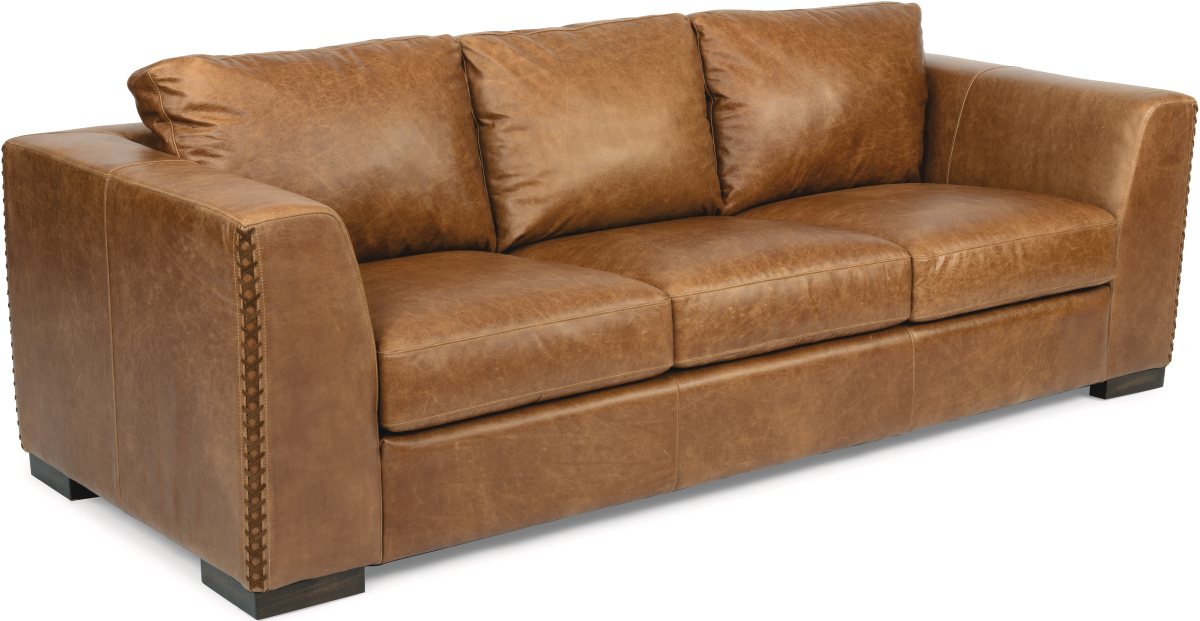 Brown leather sofa with cross stitch detail on armrest
