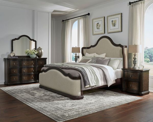 wooden bedroom set containing a matching bed, dresser, vanity, and nightstand in a traditional and modern bedroom