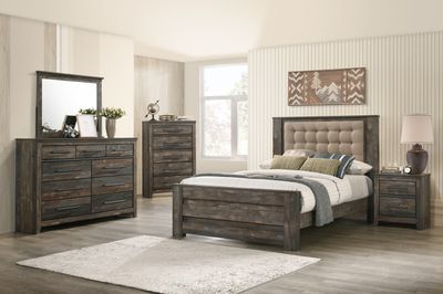 wooden bedroom set containing a vanity, dresser, bed, and nightstand in a modern farmhouse bedroom