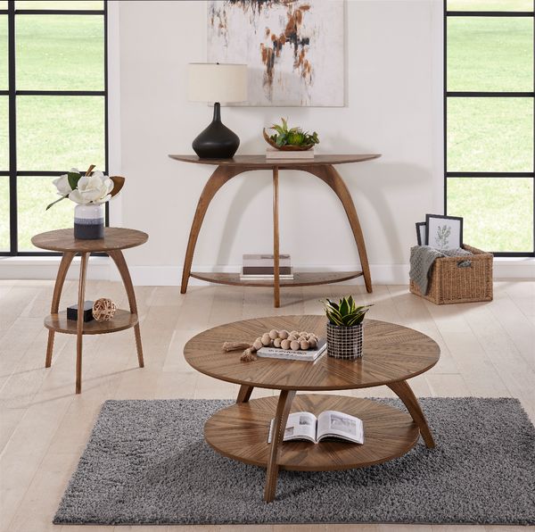 three round modern wood living room tables, one coffee table, one side table, and one counter height table, in a modern white living space