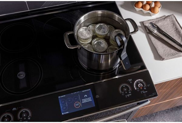 Kitchen is showcasing a GE Profile™ 30" Fingerprint Resistant Stainless Steel Slide In Induction Range