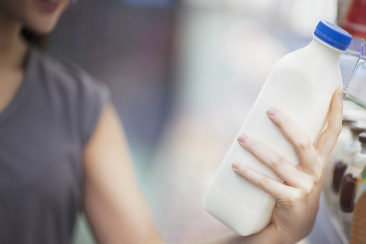 woman holding milk carton