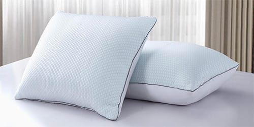 Two pillows on top of a bed