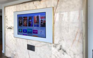 Flat screen tv mounted on marble wall