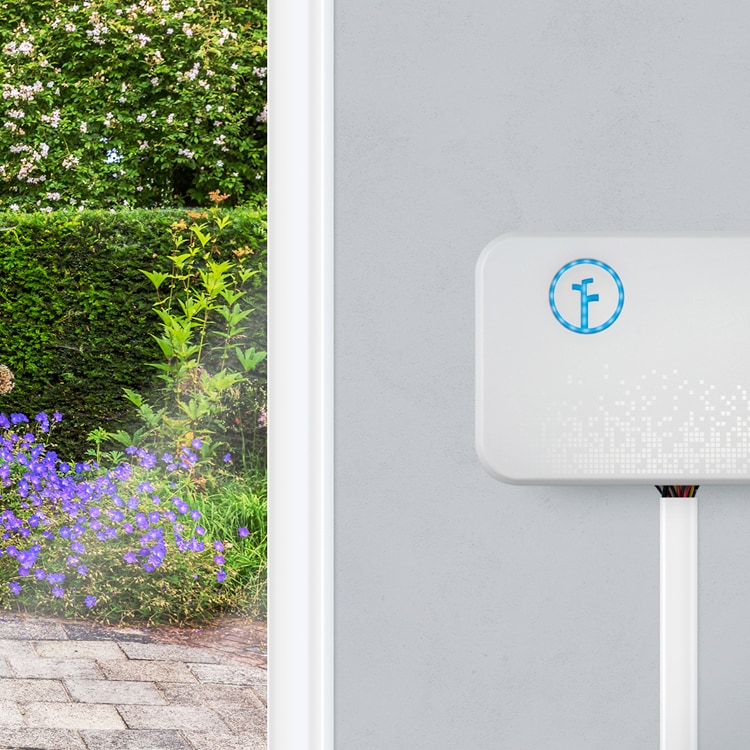 Rachio irrigation meter mounted the exterior wall of a house