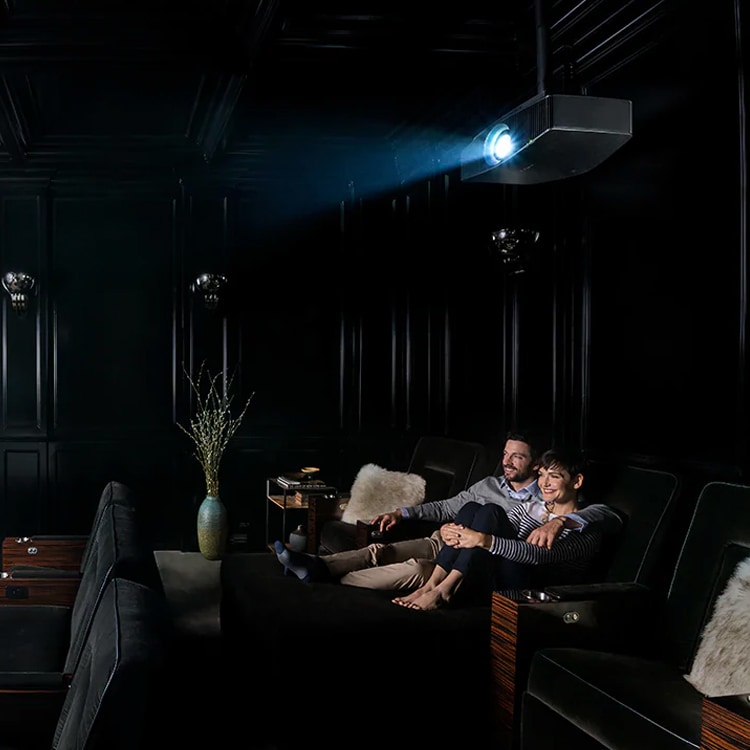 Couple watching movie in home theater with Sony projector