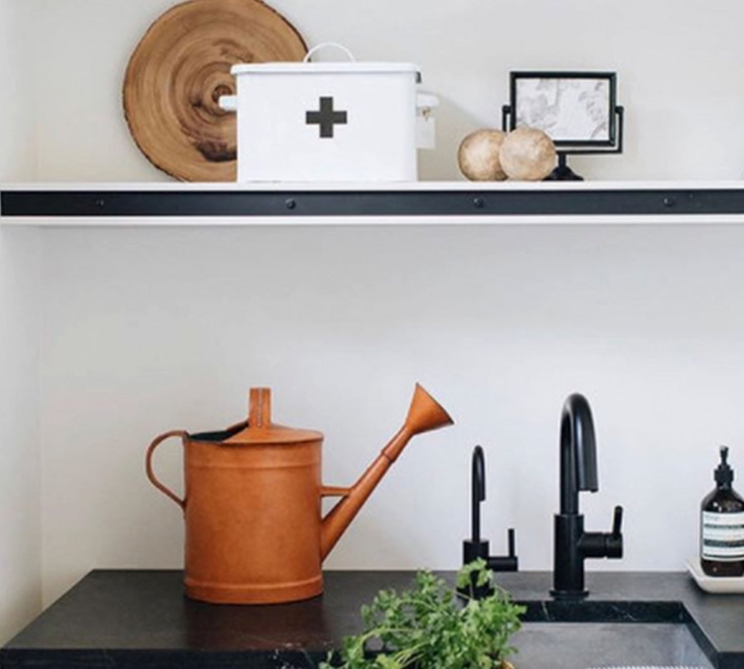 Modern shelving with rusty watering can