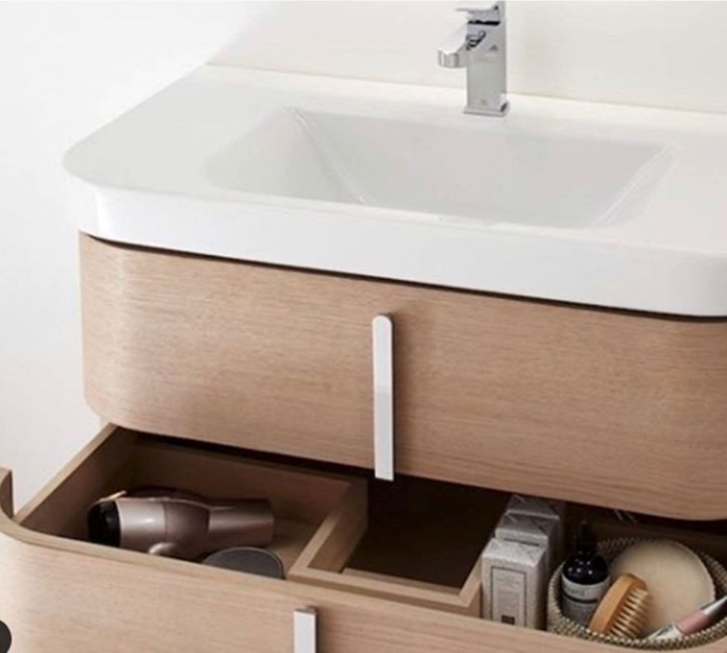 modern bathroom sink with vertical cabinet hardware and wood