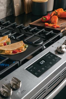 A cooktop with a mexican meal.