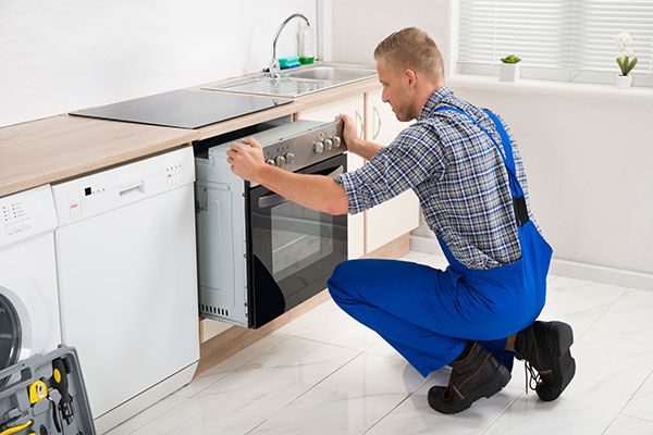 A Man installing an Oven